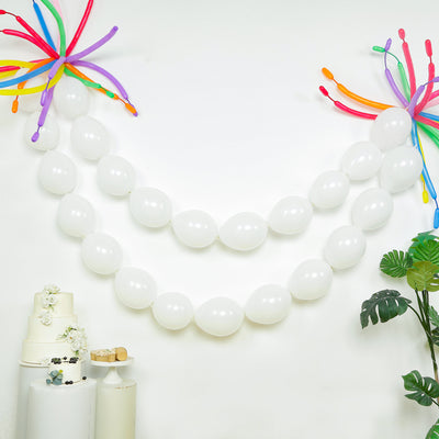 White balloons and colorful decorations for a festive celebration backdrop.
