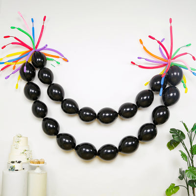 Black balloon garland with colorful accents for festive decor.