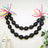 Black balloon garland with colorful accents for festive decor.