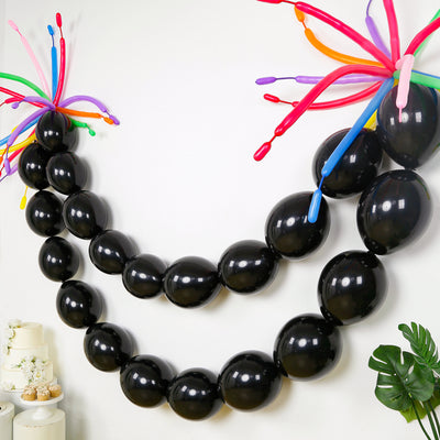 Black balloons with colorful streamers for party decoration.
