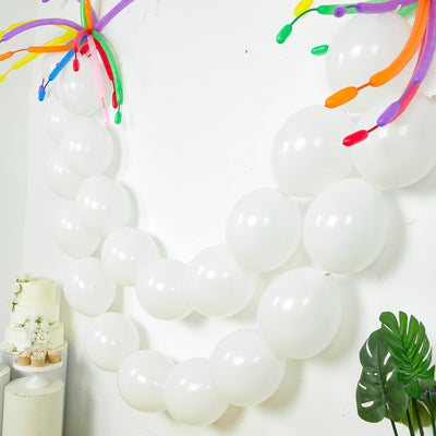White balloons arranged in a decorative arch for celebrations.