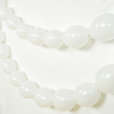 White balloon garland on a plain background