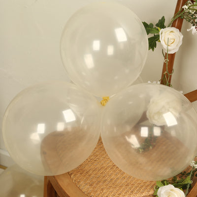 Clear balloons on a wooden chair with floral accents.