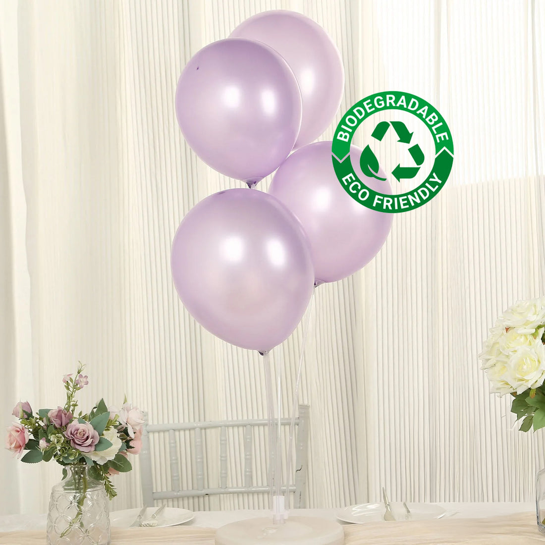 Purple biodegradable balloons with eco-friendly label on a white backdrop.