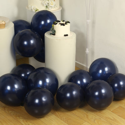 Navy blue balloons scattered around a white cake on display