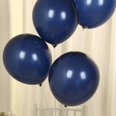 Navy blue balloons in a cluster against a light backdrop.