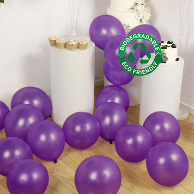 Purple biodegradable balloons on a wooden floor at a celebration.