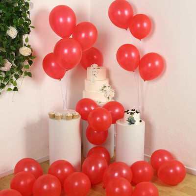 Red balloons and cake display in a festive setting.