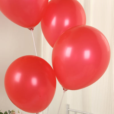 Red balloons in various sizes on a plain background.