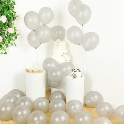 Silver balloons and cupcakes arranged for a festive celebration scene.