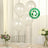 Biodegradable white balloons with eco-friendly symbol on a table setting.