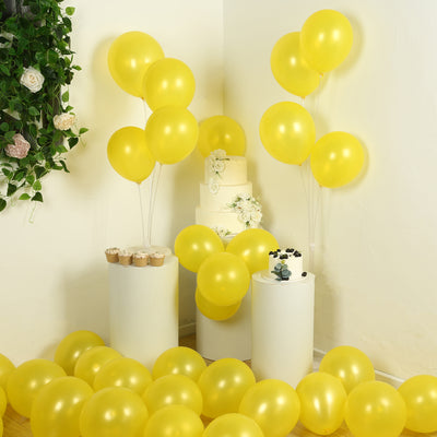 Yellow balloons and cake displayed at a festive celebration.
