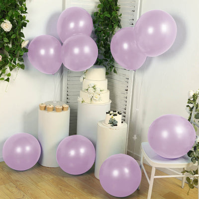 Lavender balloons with a cake and floral decor in a festive setting.