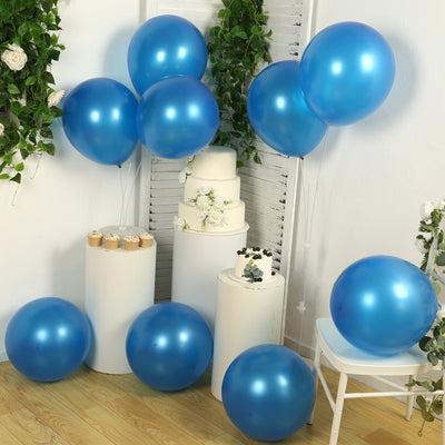Blue balloons in a decorated setting with cakes and floral accents.