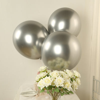 Silver balloons with white roses on a table