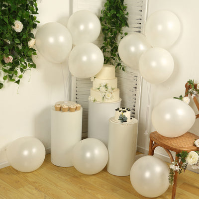 Decorative cream balloons and cake arranged in a festive setting.