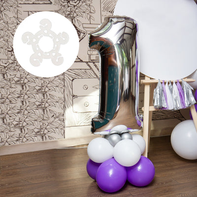 Silver number one balloon on a colorful balloon base for celebrations.