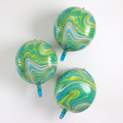 Marbled green and blue balloons on a white background