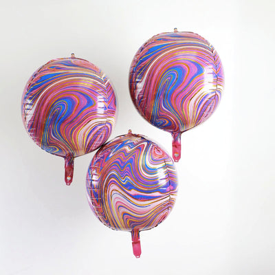 Colorful swirled balloons in pink, purple, and blue against a white background