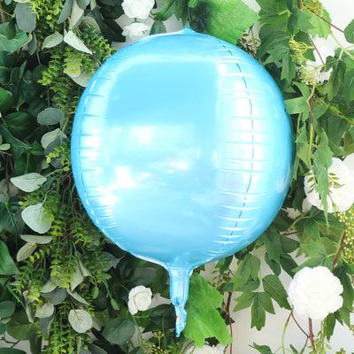 Shiny blue balloon against greenery backdrop.