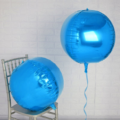 Blue foil balloons on a silver chair against a light brick wall.
