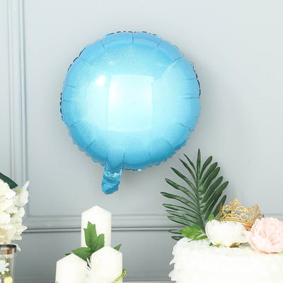 Blue balloon decoration against a gray wall with floral accents.