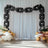Black balloon chain decoration against a white backdrop for events