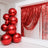 Red metallic balloons arranged artistically with shiny streamers in a festive setting.