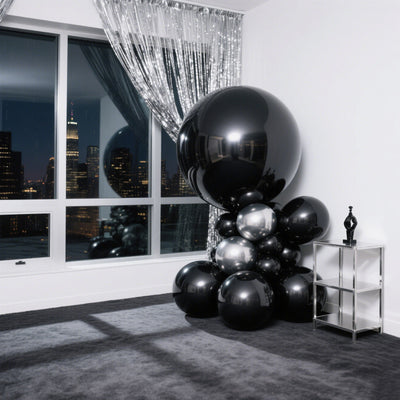 Black and silver balloon arrangement in urban apartment setting.