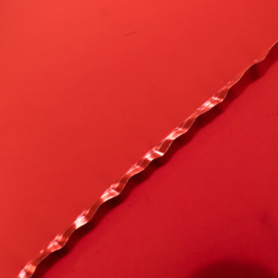 Red wavy ribbon on a matching red background