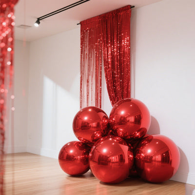 Shiny red balloons clustered in a stylish indoor setting.