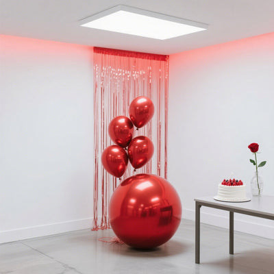 Red metallic balloons and a large ball in a festive interior setting.