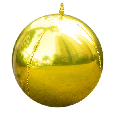Shiny gold balloon with reflections of buildings and grass