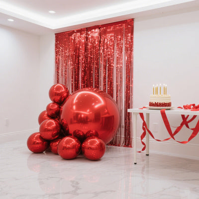 Red balloons and a decorated cake on a table in a festive setting.