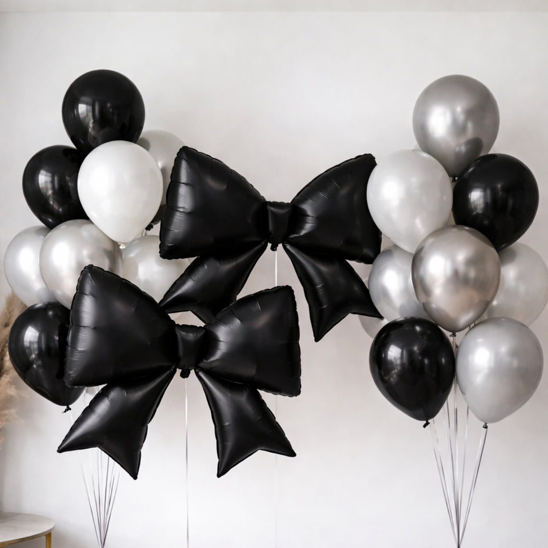 Black and silver balloons with large bow shapes, ideal for celebrations.