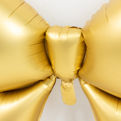 Gold balloon bow decoration for events and celebrations