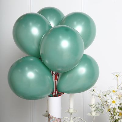 Mint green balloons arranged in a bouquet against a white backdrop.