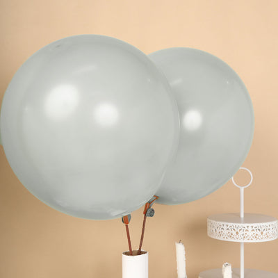 Two large gray balloons against a beige background.