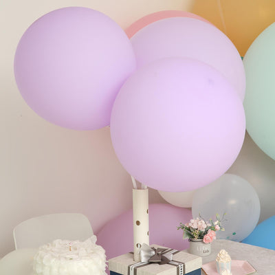 Pastel balloons in a festive setting with a cake and flowers.