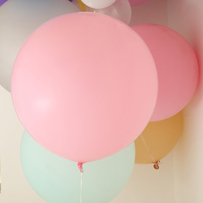 Colorful balloons in various shades including pink, green, and yellow.