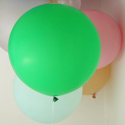 Colorful balloons in various sizes floating against a light background.