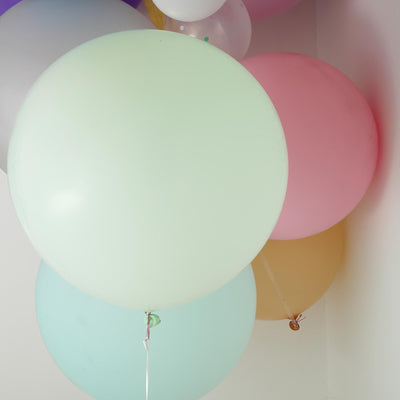 Colorful balloons in various shades, including mint, pink, and yellow.