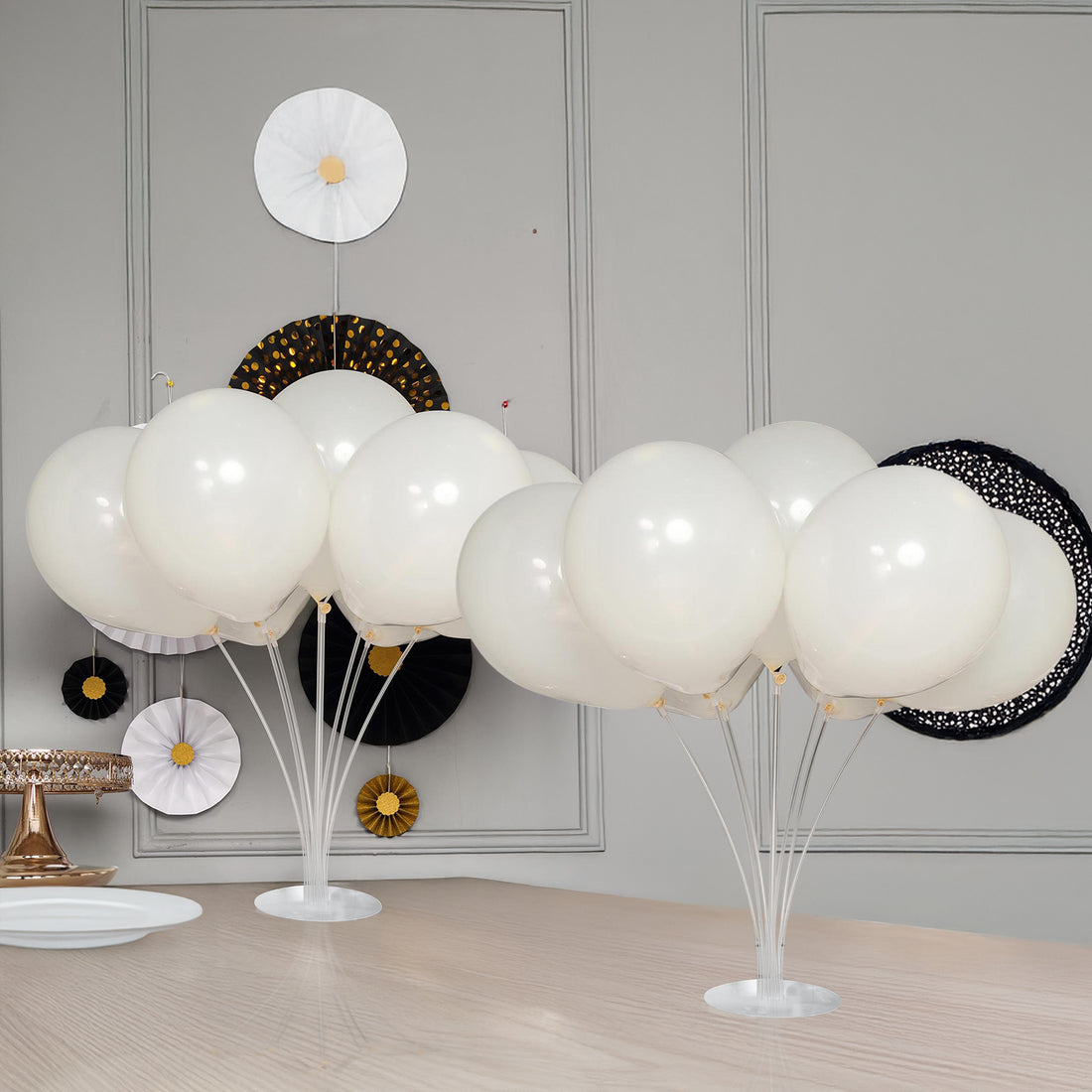 White balloons arranged elegantly on a table with decorative accents. #whtbkgd