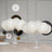 White balloons arranged elegantly on a table with decorative accents. #whtbkgd