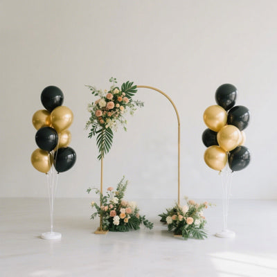 Elegant wedding arch with floral arrangement and gold-black balloons