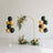 Elegant wedding arch with floral arrangement and gold-black balloons