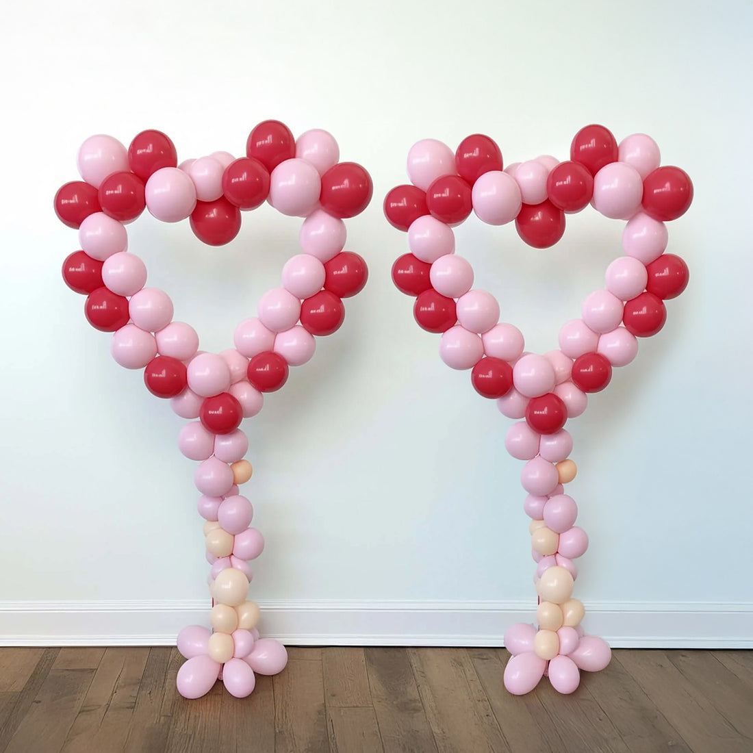 Heart-shaped balloon decorations in red and pink tones. #whtbkgd