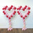 Heart-shaped balloon decorations in red and pink tones. #whtbkgd