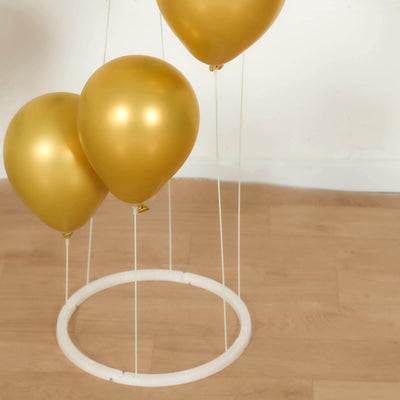 Gold balloons clustered around a white circular stand.