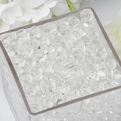 Clear decorative gel beads in a glass container.